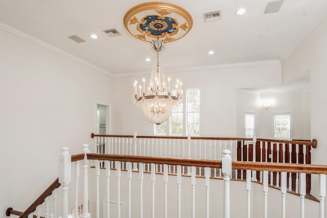 interior space featuring ornamental molding, a healthy amount of sunlight, and an inviting chandelier