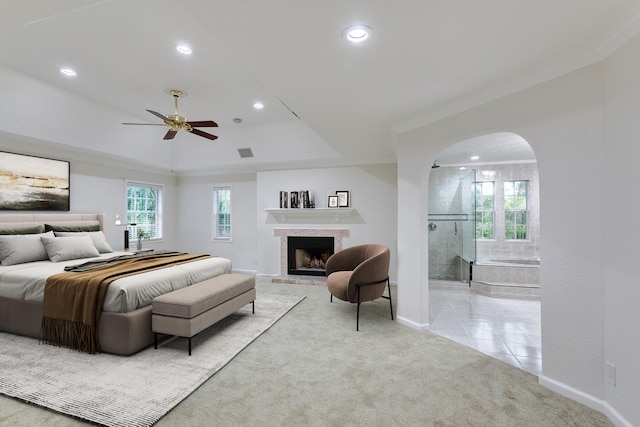 bedroom featuring ensuite bath, crown molding, ceiling fan, and light colored carpet