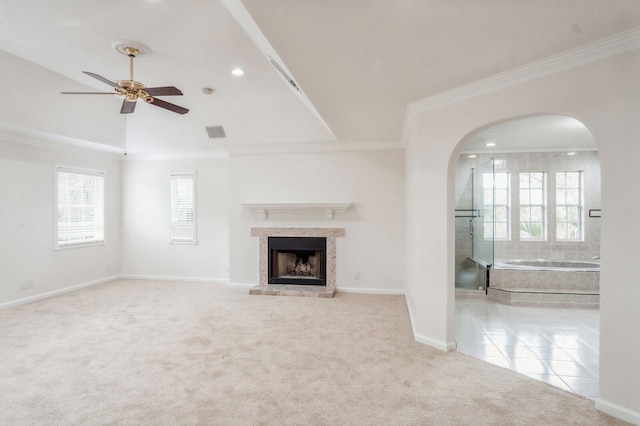 unfurnished living room with crown molding, light colored carpet, and ceiling fan