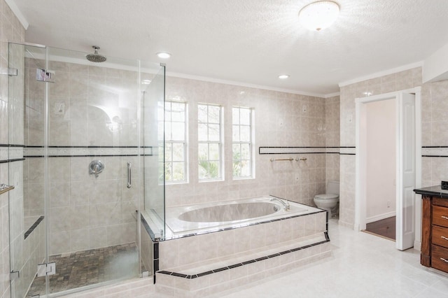 full bathroom featuring toilet, tile walls, independent shower and bath, vanity, and a textured ceiling