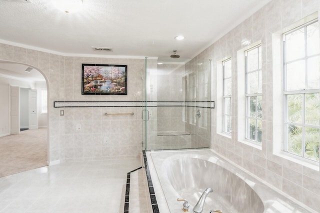 bathroom with crown molding and plus walk in shower