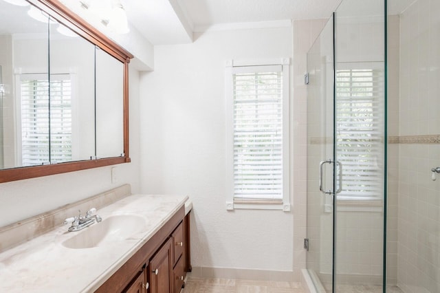 bathroom with crown molding, vanity, and an enclosed shower