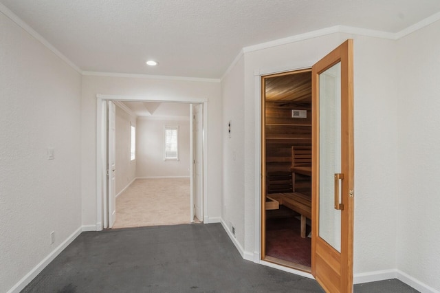 corridor featuring dark colored carpet and crown molding