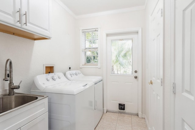 laundry room featuring cabinets, separate washer and dryer, crown molding, sink, and light tile patterned flooring