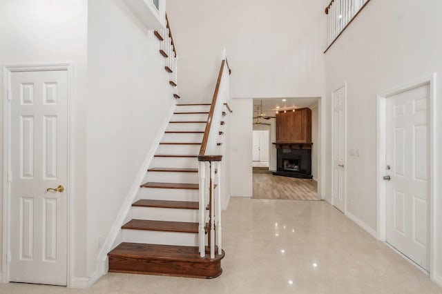 staircase featuring a towering ceiling