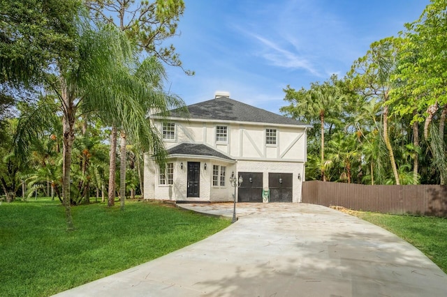 view of front of property with a garage and a front lawn