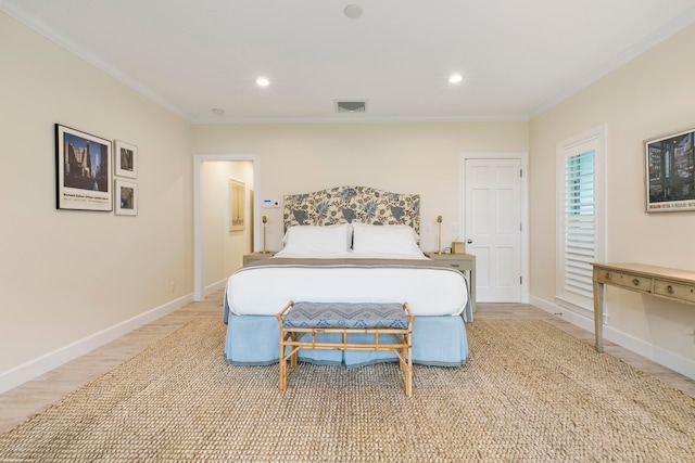 bedroom with light wood-type flooring and crown molding