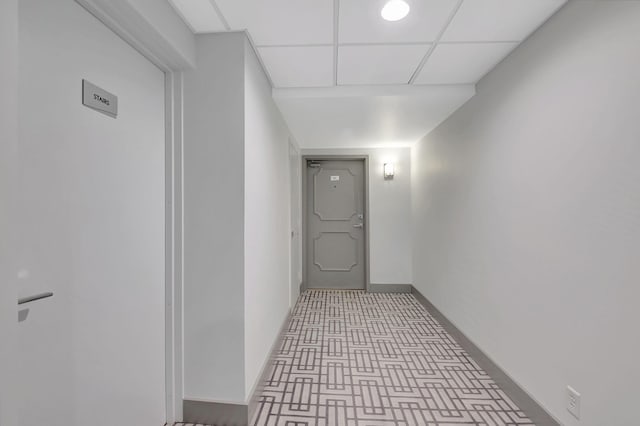 hallway featuring a drop ceiling