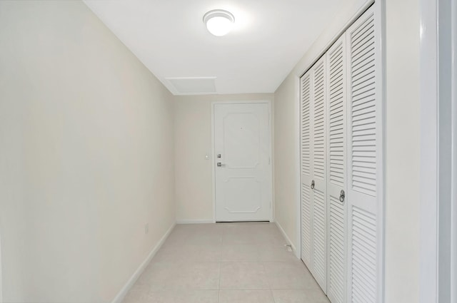 hall with light tile patterned floors