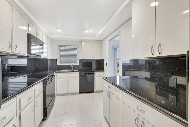 kitchen with light tile patterned floors, backsplash, white cabinets, and black appliances