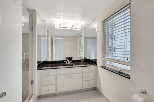 bathroom with vanity, walk in shower, and tile patterned floors