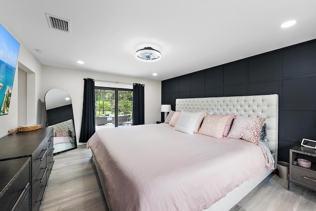 bedroom featuring light hardwood / wood-style floors and access to exterior