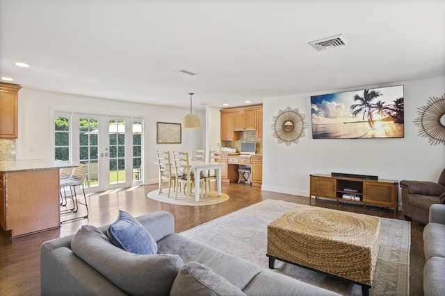 living room with baseboards, visible vents, dark wood-type flooring, french doors, and recessed lighting