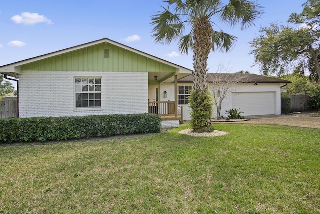 single story home with brick siding, a front yard, and an attached garage