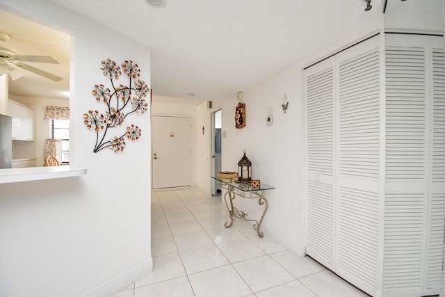 hall with light tile patterned floors