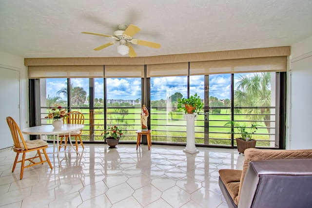 sunroom featuring ceiling fan