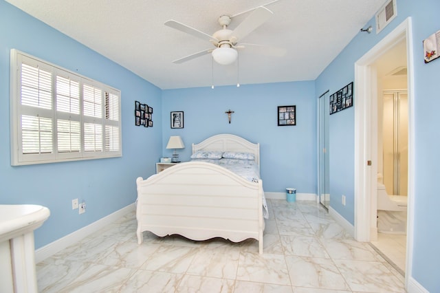 bedroom with light tile patterned flooring, ceiling fan, and ensuite bathroom