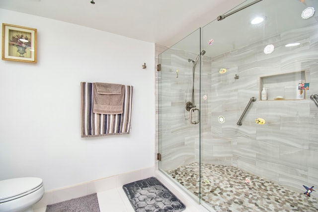 bathroom with a shower with door, toilet, and tile patterned flooring