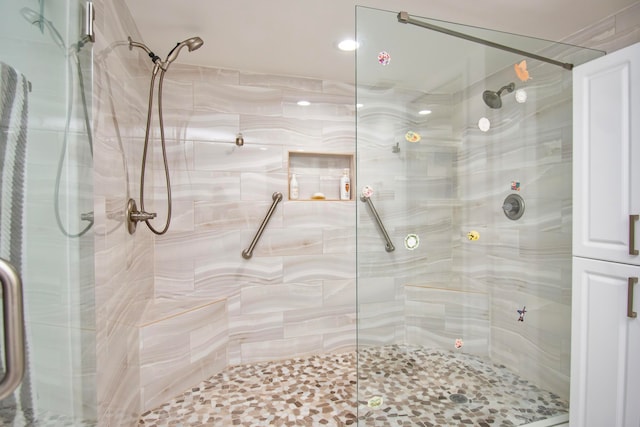 bathroom with a shower with shower door