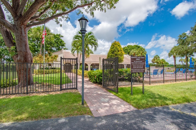 view of gate featuring a lawn