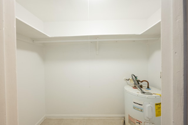 walk in closet featuring electric water heater and tile patterned floors