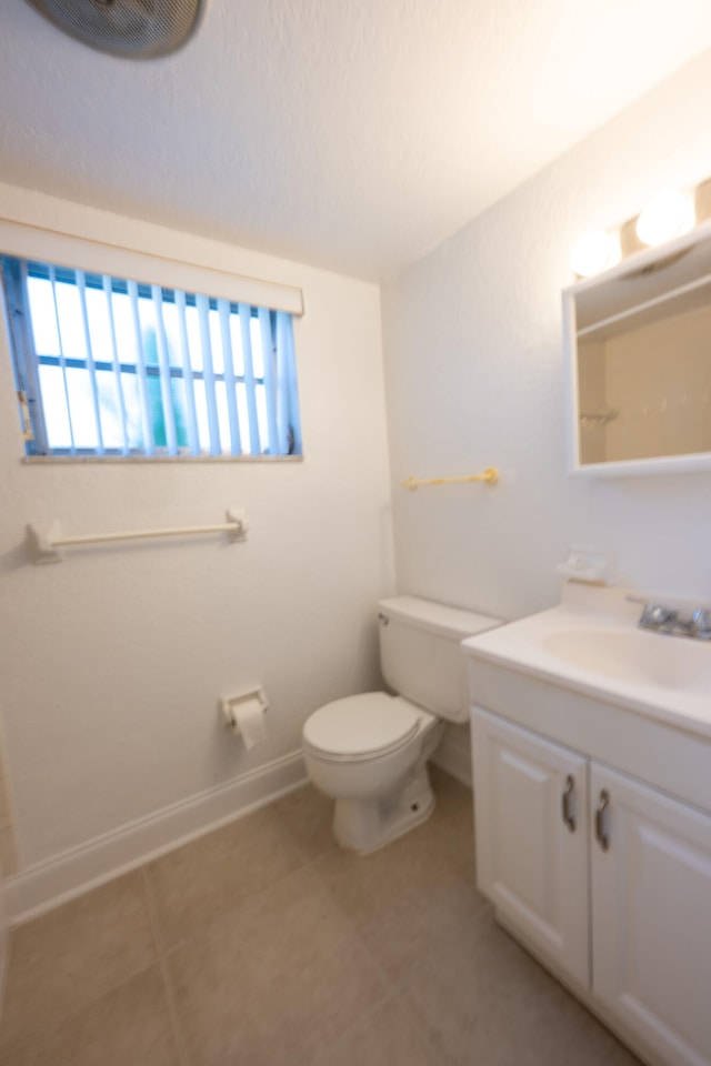 bathroom featuring vanity, toilet, and tile patterned flooring