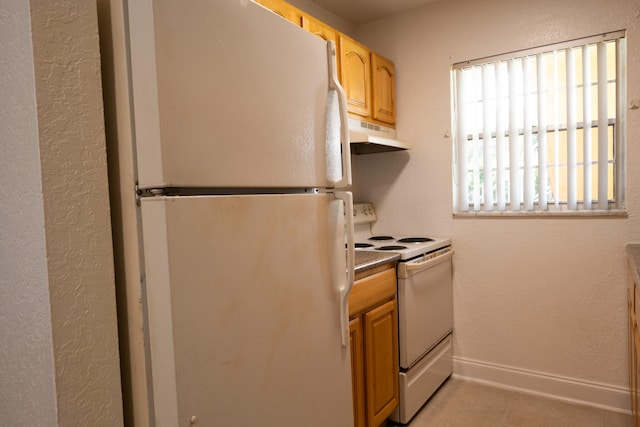 kitchen featuring white appliances and light tile patterned floors