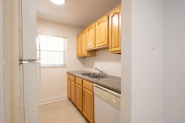 kitchen featuring sink, light brown cabinets, white dishwasher, and light tile patterned flooring