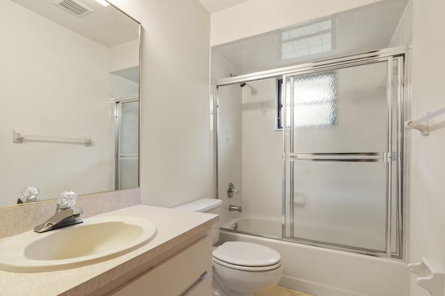 full bathroom featuring tile patterned flooring, toilet, bath / shower combo with glass door, and vanity