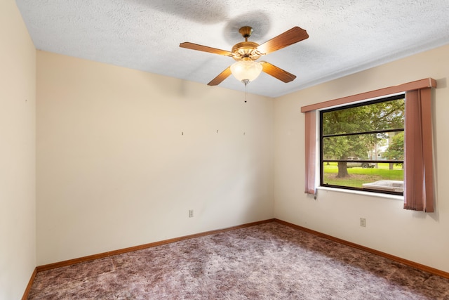 spare room featuring ceiling fan, a textured ceiling, and carpet floors