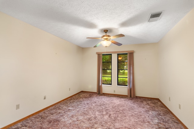 carpeted spare room featuring a textured ceiling and ceiling fan