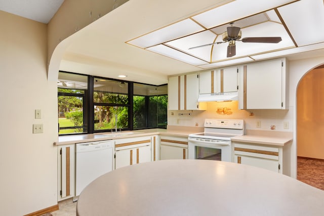 kitchen featuring ceiling fan, backsplash, white cabinets, sink, and white appliances