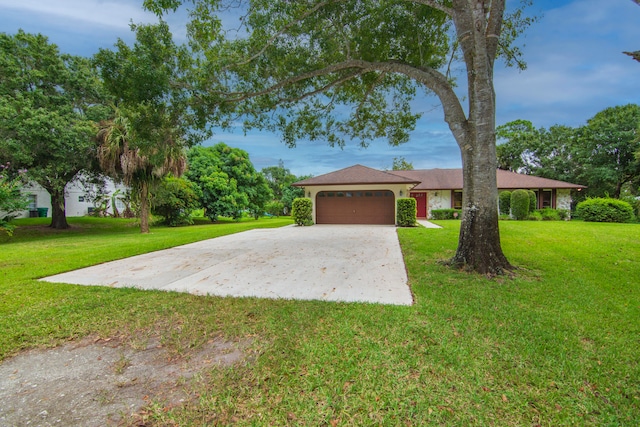 single story home with a front yard and a garage