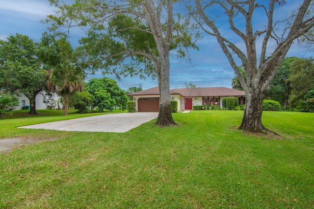 ranch-style house featuring a garage and a front lawn