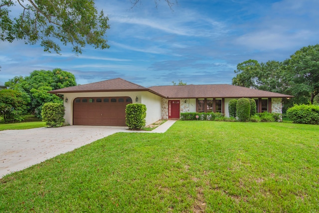 single story home featuring a garage and a front yard