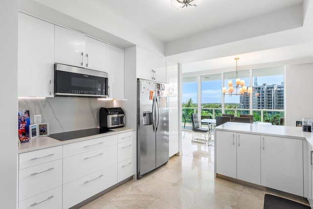 kitchen with stainless steel appliances, tasteful backsplash, light countertops, and white cabinets