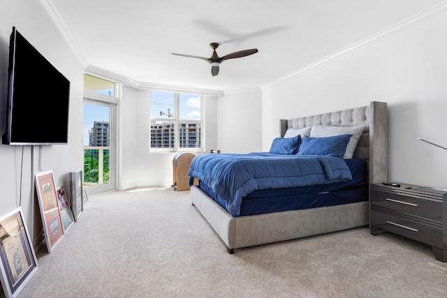 bedroom featuring ornamental molding, ceiling fan, and light colored carpet