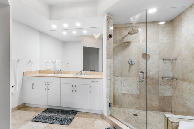 bathroom featuring vanity, a shower with door, and tile patterned floors