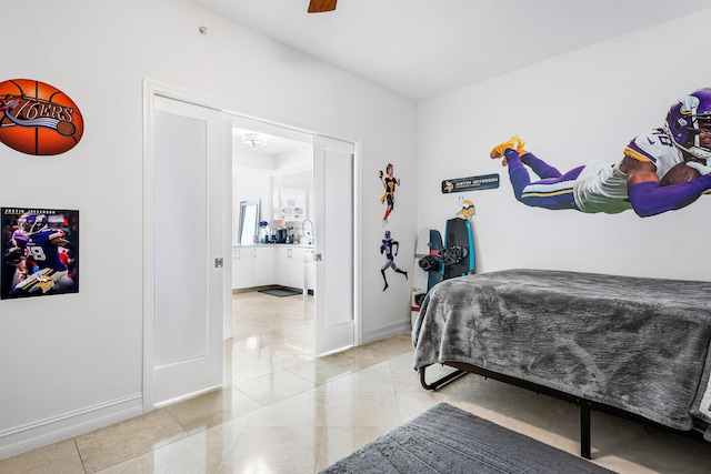 bedroom featuring light tile patterned floors, baseboards, and a ceiling fan