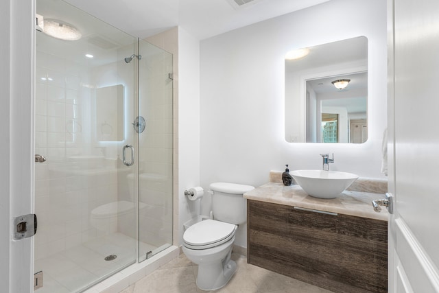 bathroom featuring tile patterned flooring, vanity, toilet, and walk in shower