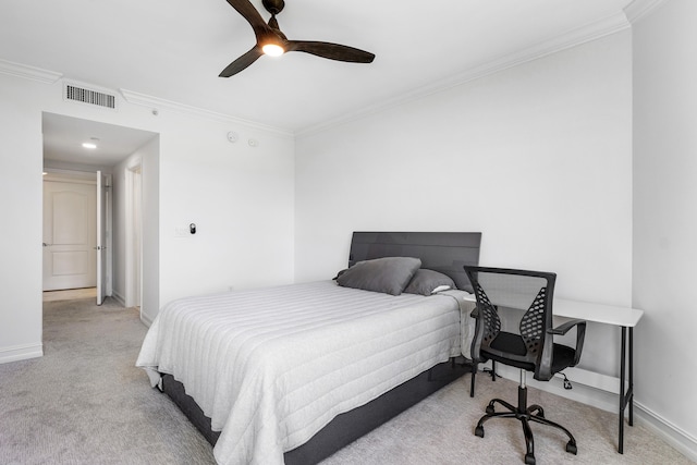 carpeted bedroom featuring ornamental molding and ceiling fan