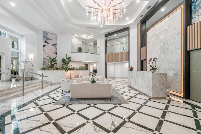 interior space with a tray ceiling, a notable chandelier, crown molding, recessed lighting, and baseboards