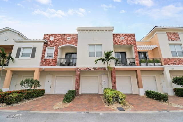 view of property with a garage and a balcony