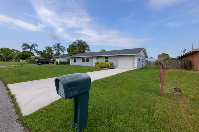 single story home featuring a front lawn and a garage