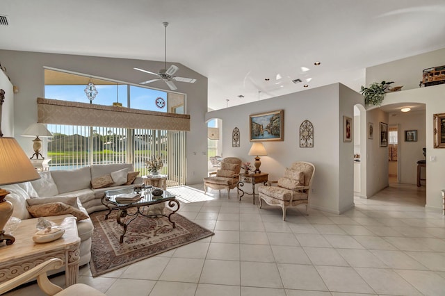 living room featuring ceiling fan, light tile patterned floors, and high vaulted ceiling