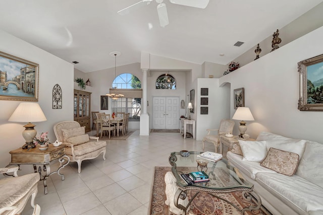 tiled living room with ceiling fan with notable chandelier and lofted ceiling