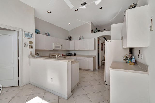 kitchen with kitchen peninsula, white appliances, light tile patterned floors, high vaulted ceiling, and white cabinetry