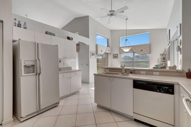 kitchen with white cabinets, light tile patterned floors, white appliances, and sink