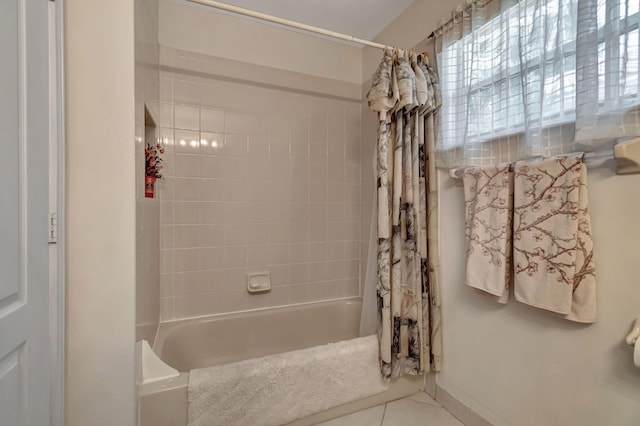 bathroom with tile patterned flooring and shower / bathtub combination with curtain