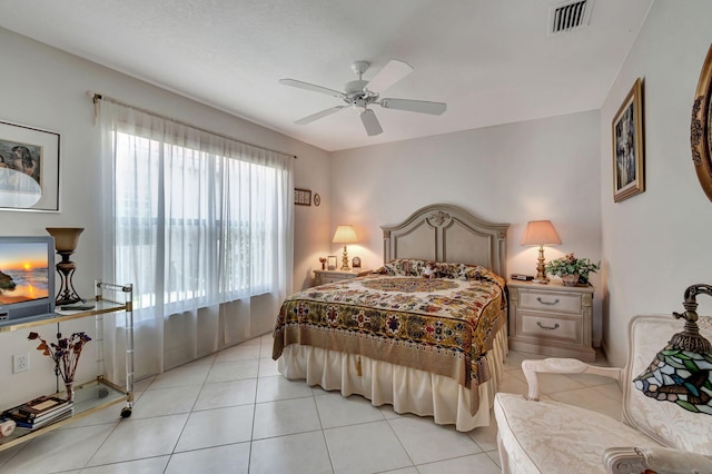 bedroom with ceiling fan and light tile patterned floors